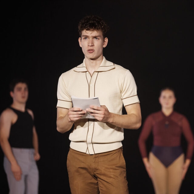 Senior male acting student in street clothes reads a script