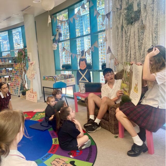 Acting students read to Kindergarten little ones